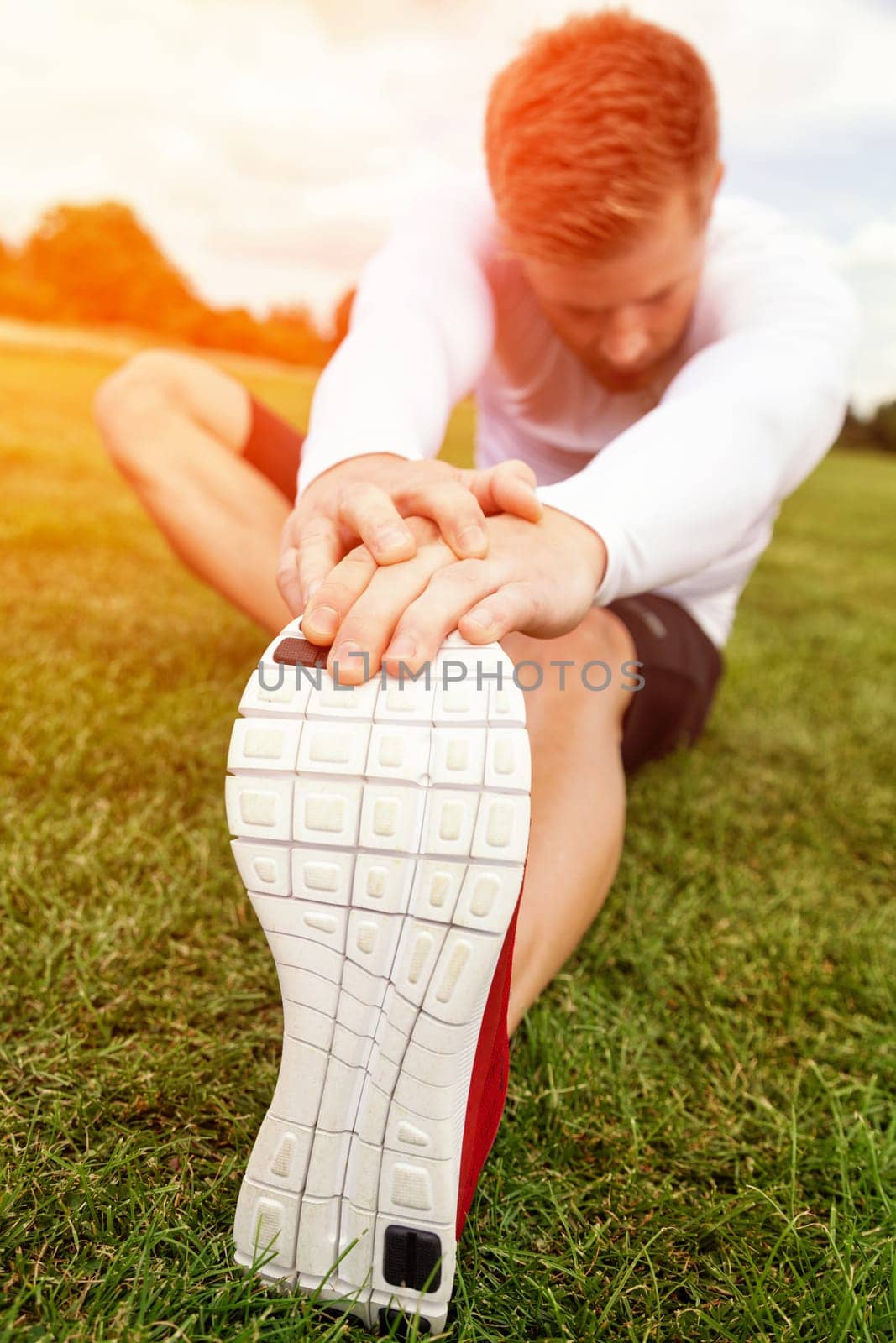 Stretching out muscles in the park on a sunny day