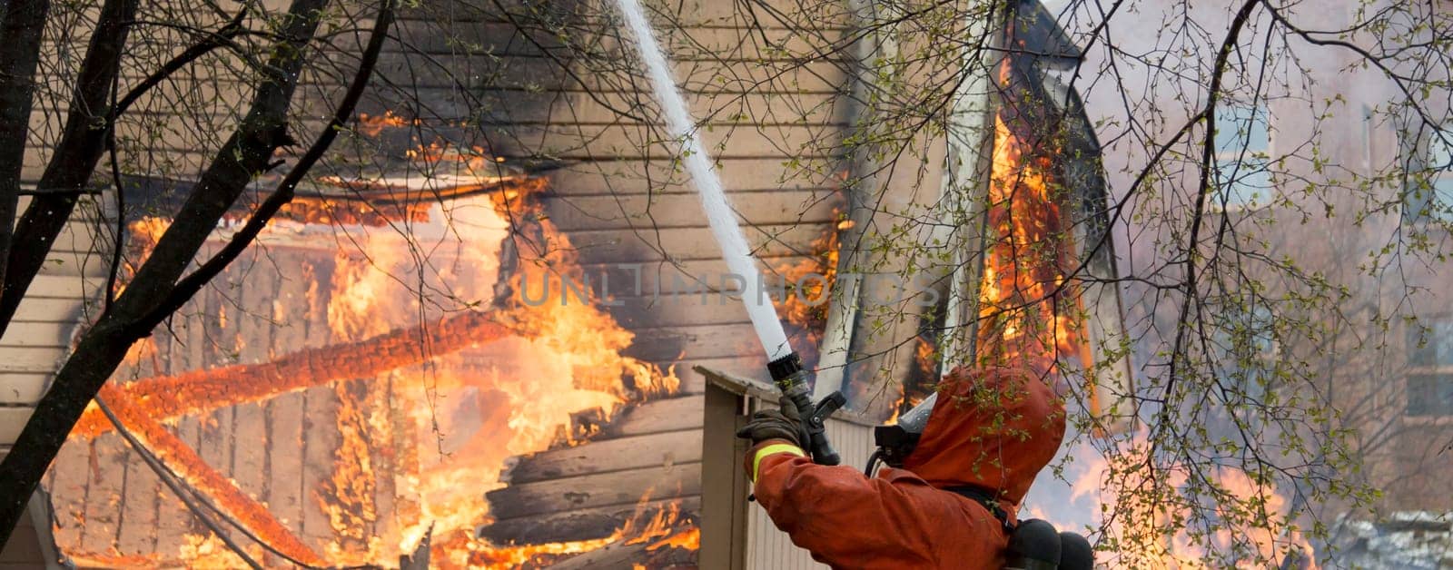 Firefighter Fighting Fire in house with water
