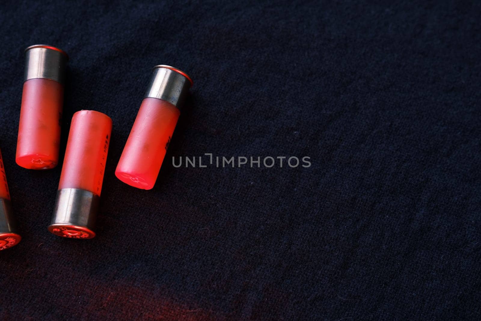 Shotgun shells on a black surface. Ammunition for 12 gauge smoothbore weapons. Hunting ammunition. Dark background