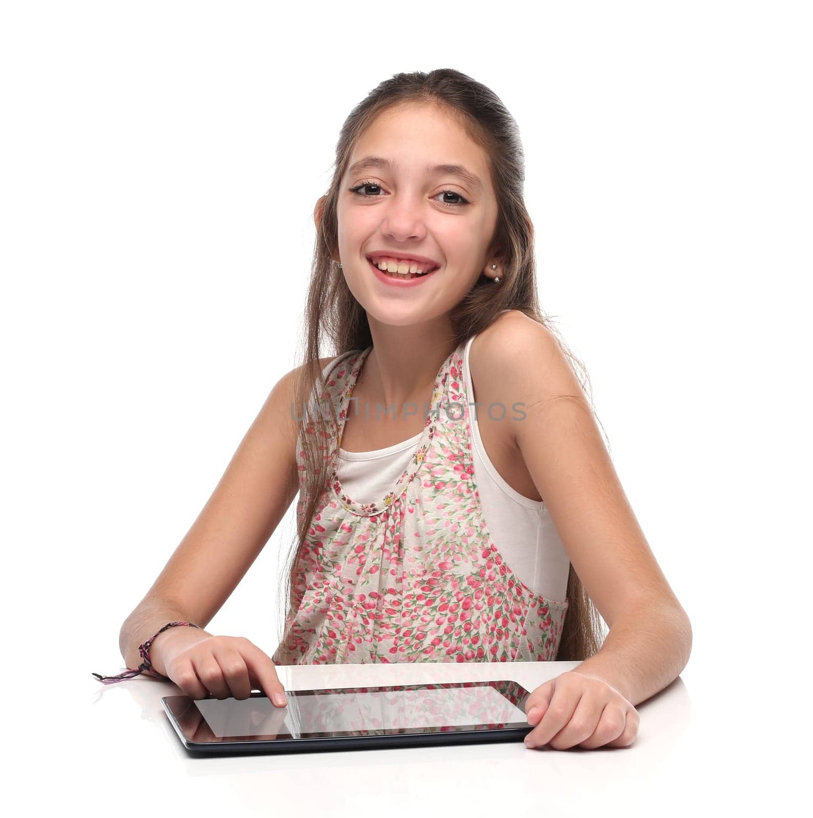 Beautiful pre-teen girl with a tablet computer. Isolated. Clipping path for the screen