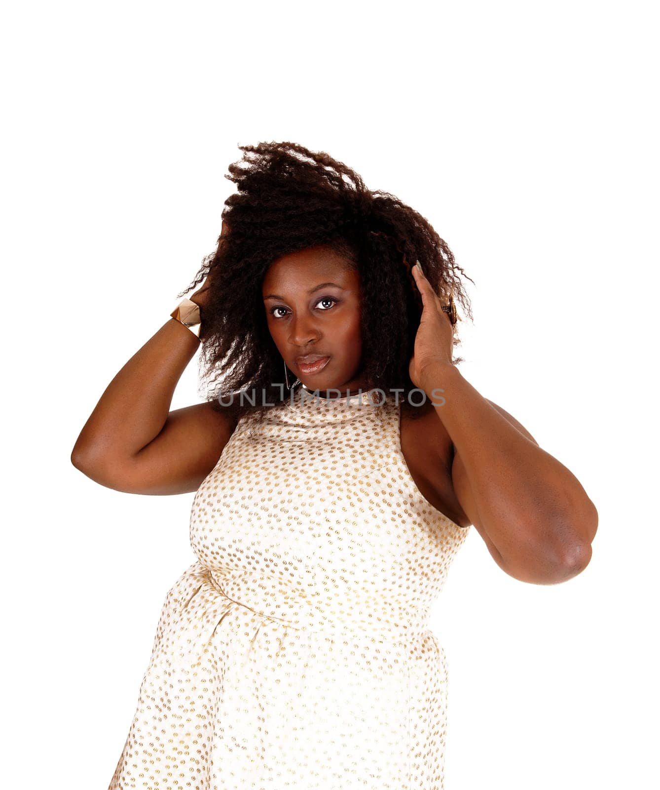 A portrait picture of a African American women in a beige dress and messy.hair standing isolated for white background..