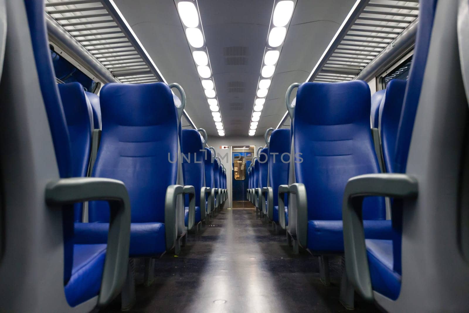 Perspective view of seats from the aisle inside a passenger train