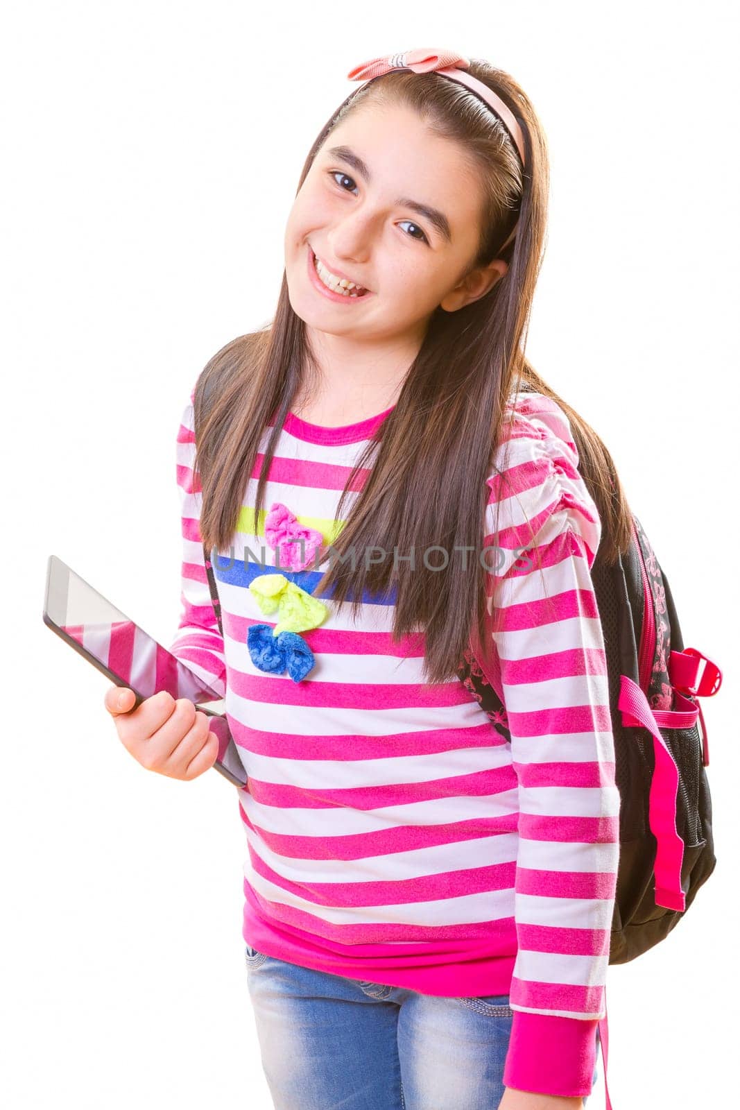 Beautiful teenager girl in casual clothes with backpack holding digital tablet in her hand.
