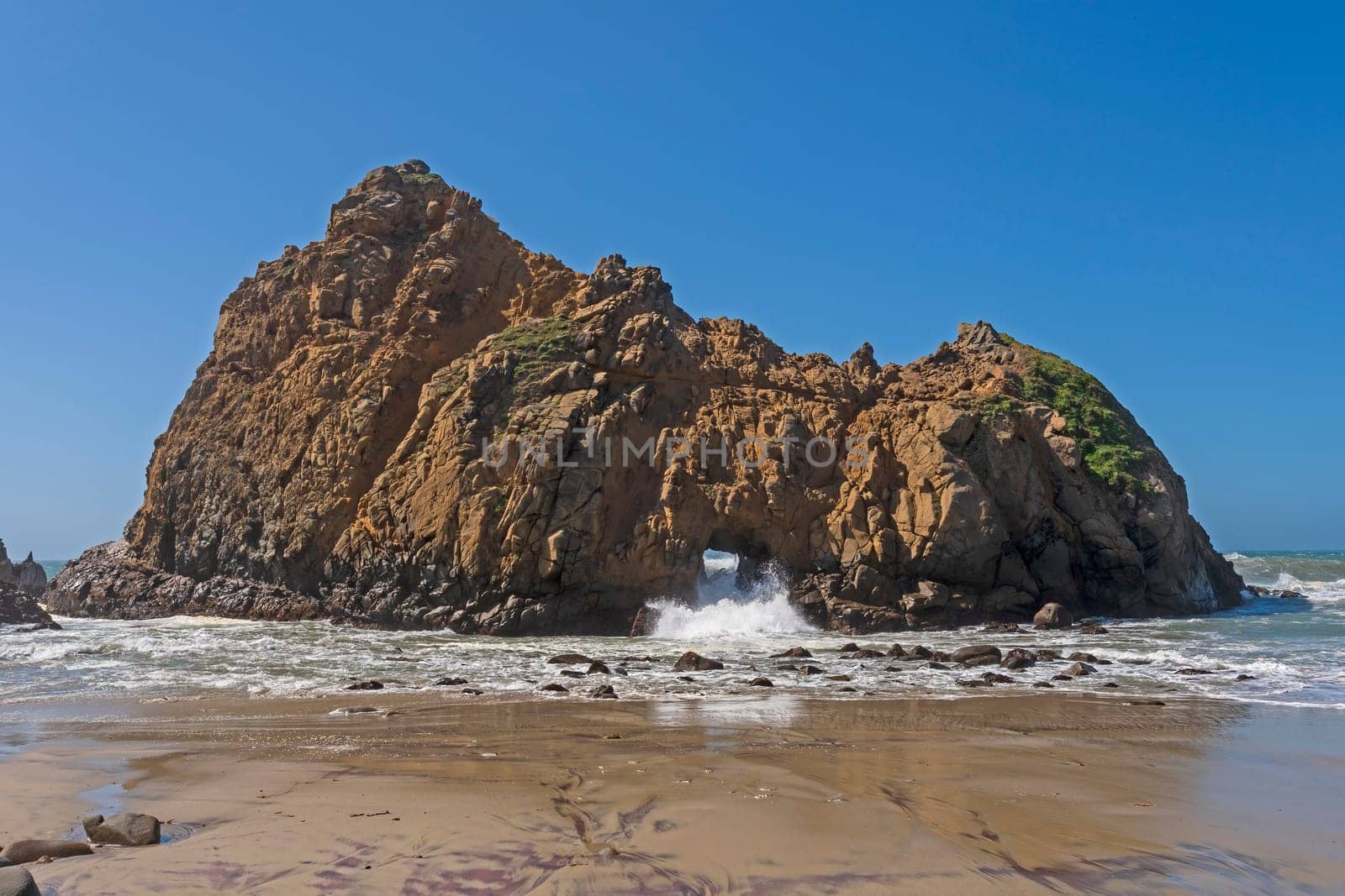Water Crashing Through a Sea Arch in Pfeiffer Beach in California