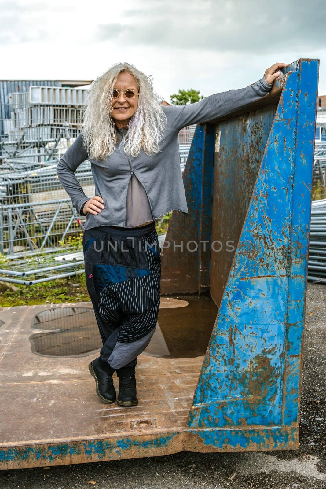 Beautiful woman in the 50s with blue container in the background
