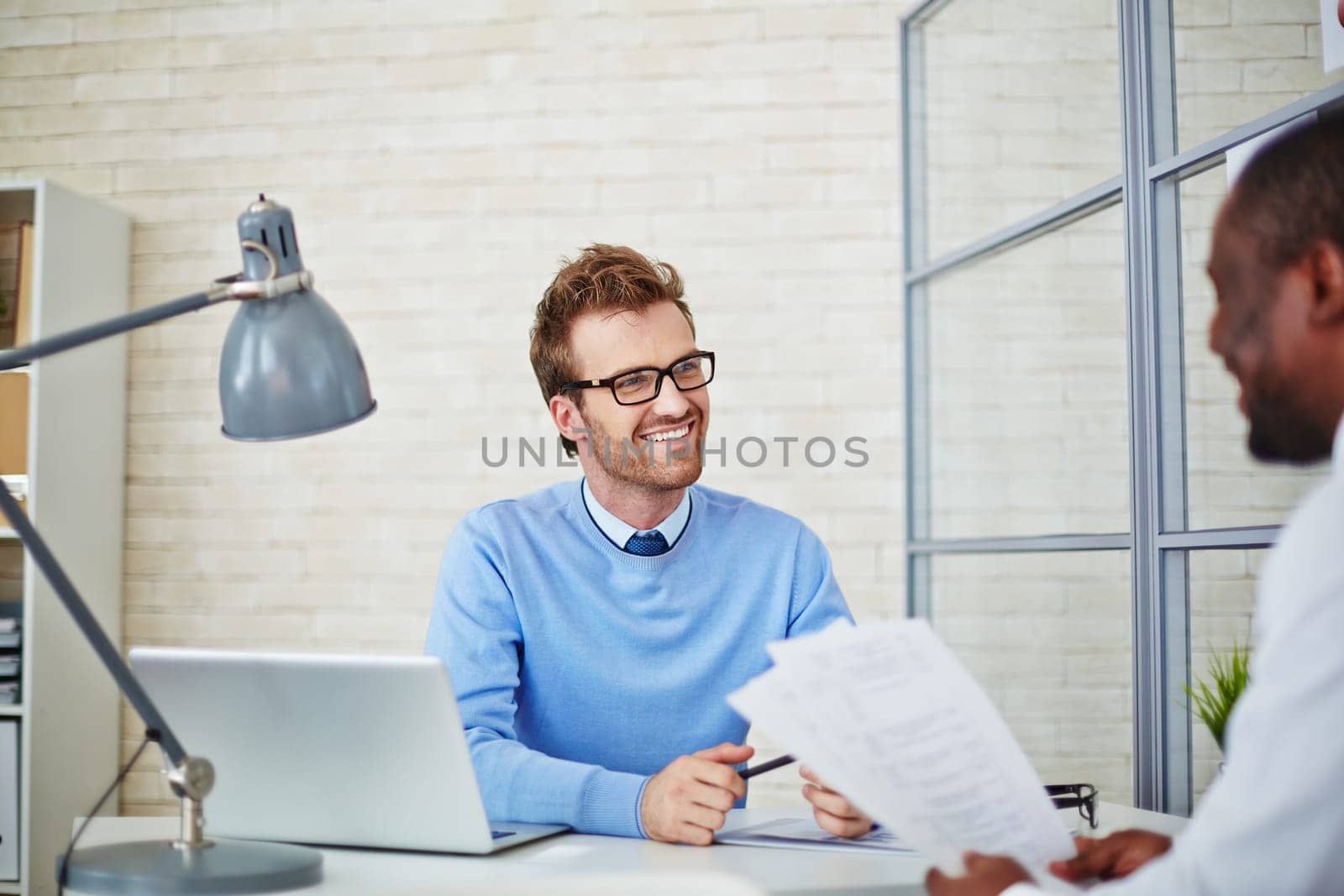 Young manager listening to man hiring for job
