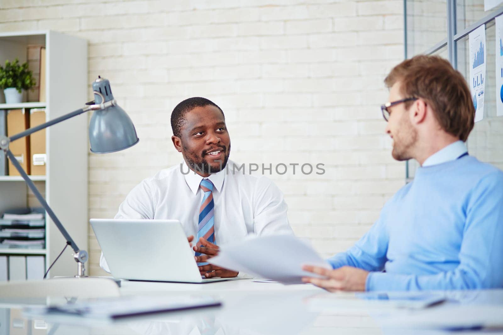 Young businessmen interacting at meeting