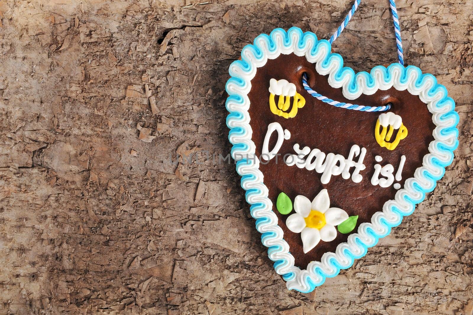 original Bavarian Oktoberfest gingerbread heart on real brown tree bark