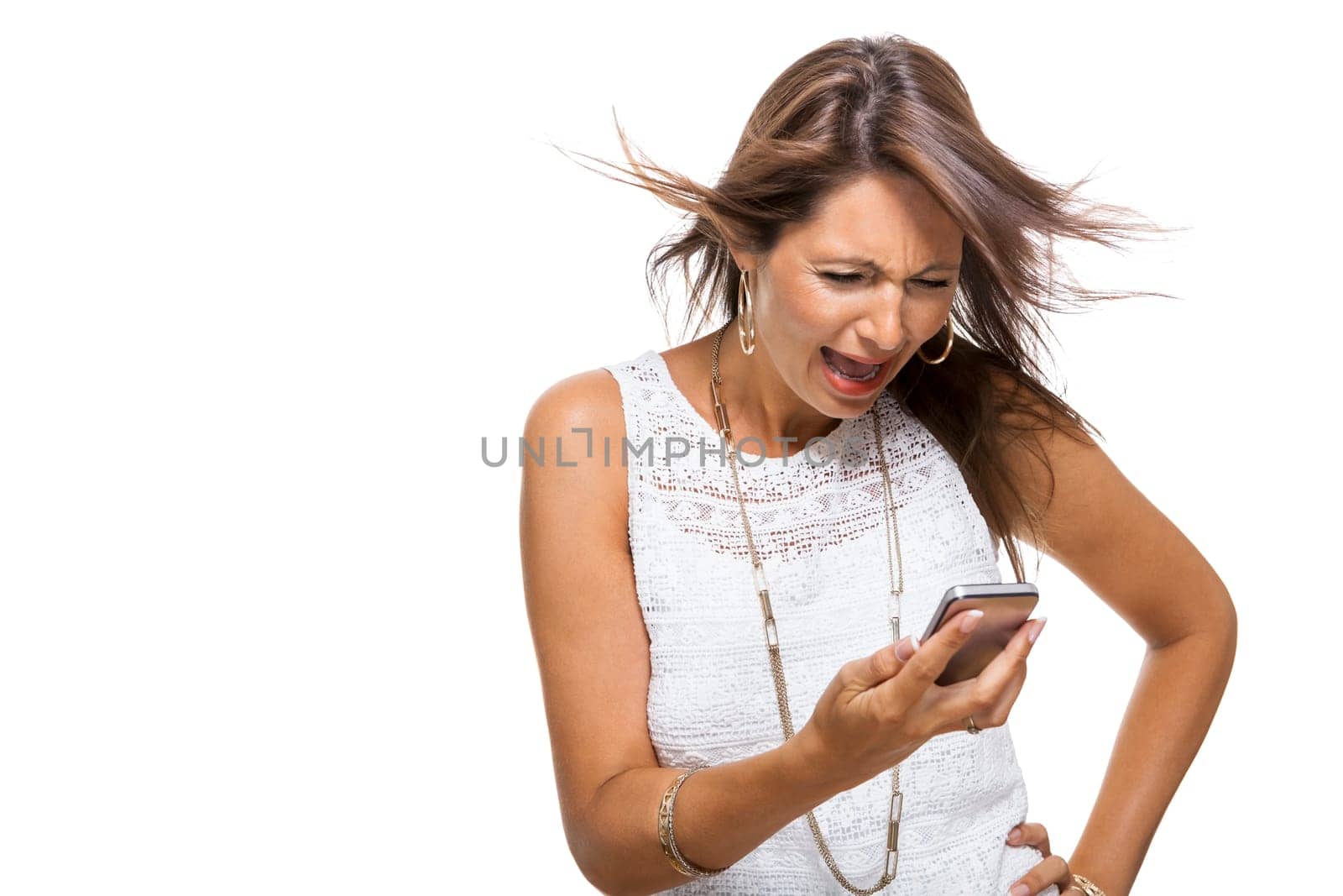 Young attractive woman reacts to a text message on her phone smartphone with open dark hair with text clearance isolated freeholder