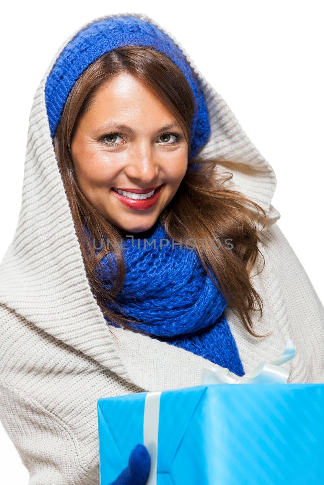 Young attractive woman with blue wool hat holds a gift for birthday Christmas in hand isolated on white background