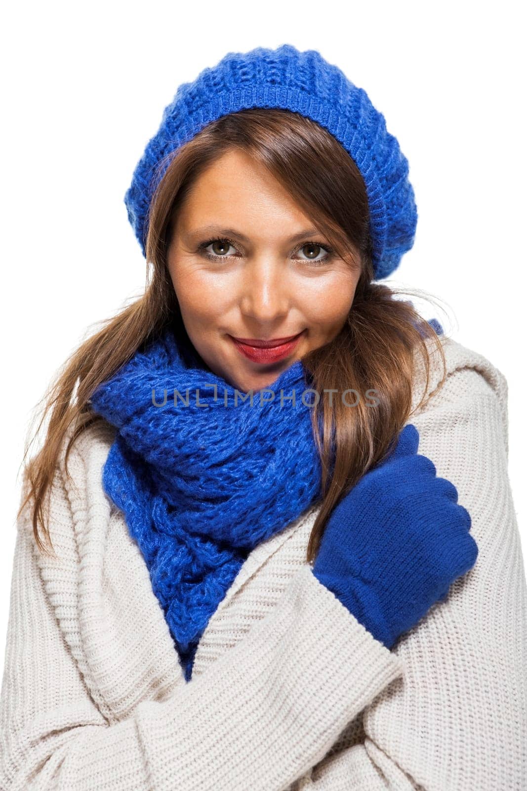 attractive pretty young woman with blue wool hat with long dark hair in winter isolated on white background