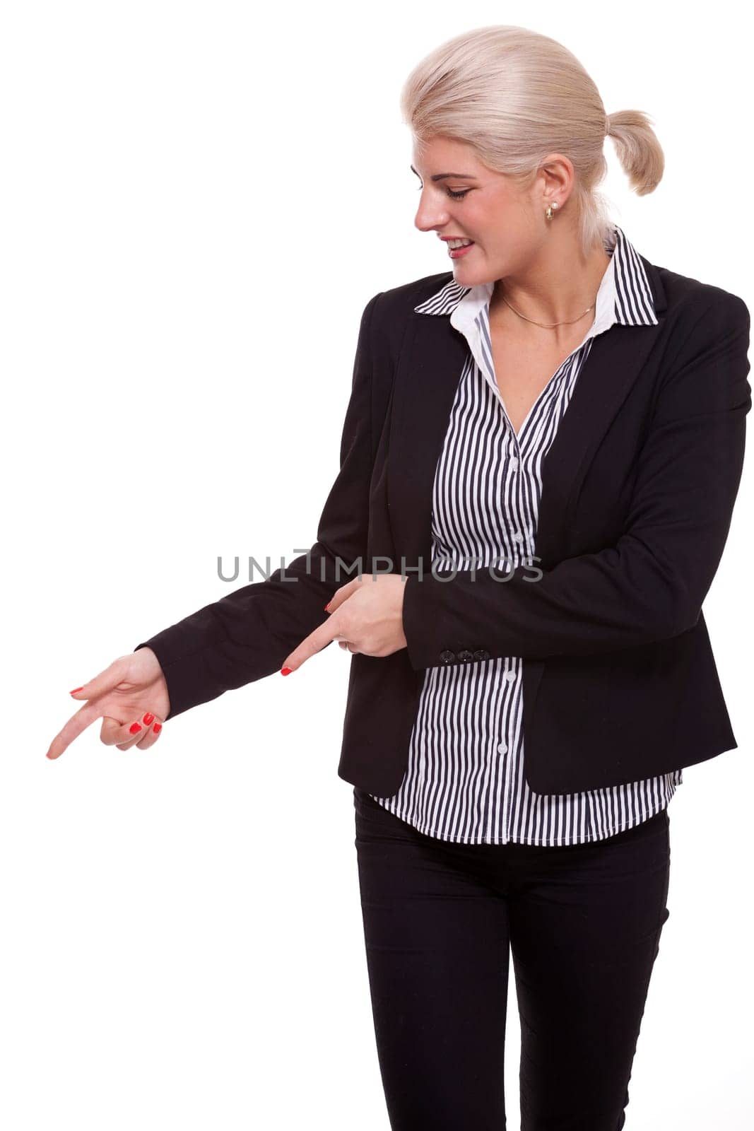 Young woman in business clothes shows with both arms in one direction isolated on white background