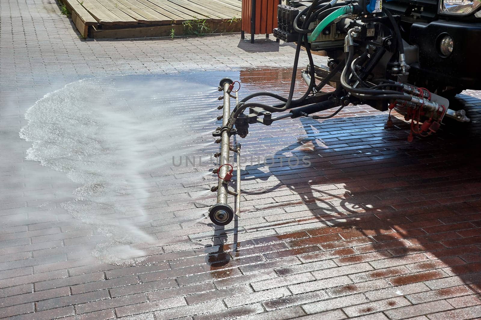 A special machine washes city paths and roads with water. High quality photo
