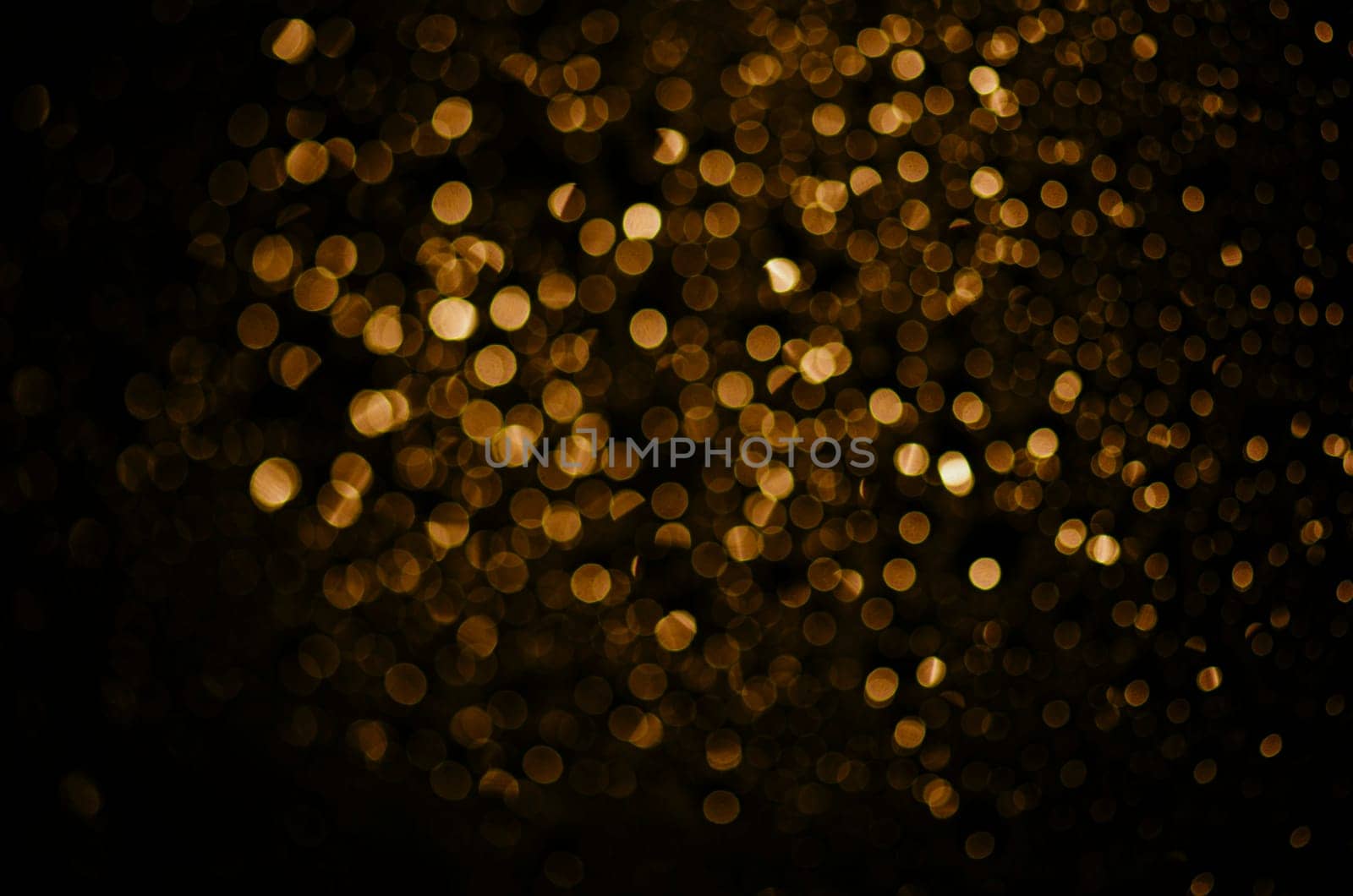 Blur neon gold light circle background. Sparkling firework bokeh dots in retro film filter style. Luxury and classy new year and christmas celebration party textured backdrop. Blurry golden dust particles.