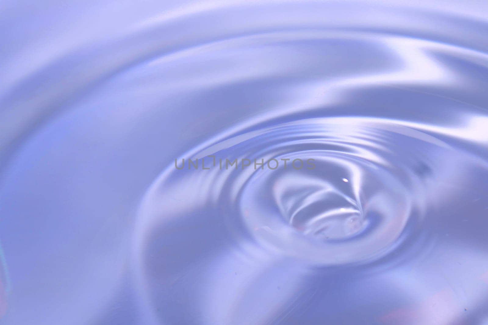 Beautiful blue background in the form of circles on the water. Universal abstract blurred background.