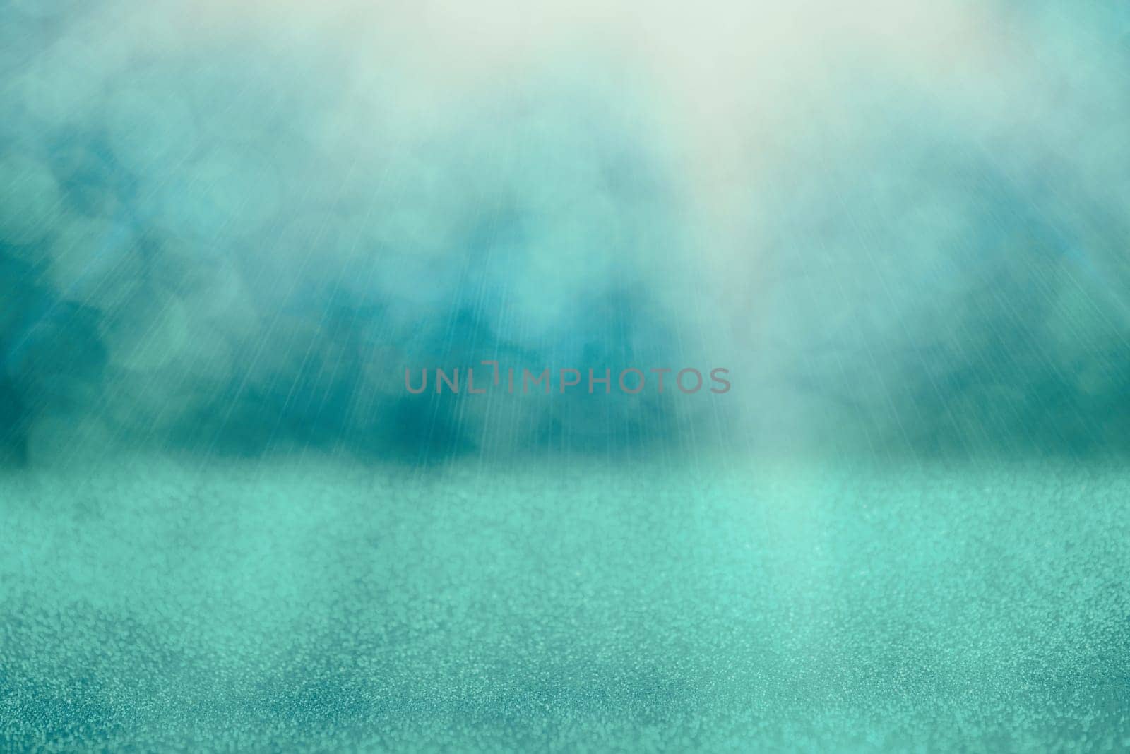 Blue bokeh background for christmas, defocused round lights and sunbeams, flare overlay