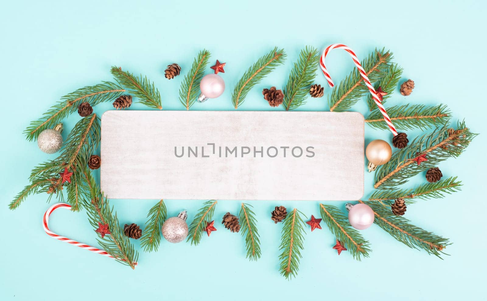 Christmas holiday background, frame with fir branches, baubles, candy cane and cones, winter season greeting card