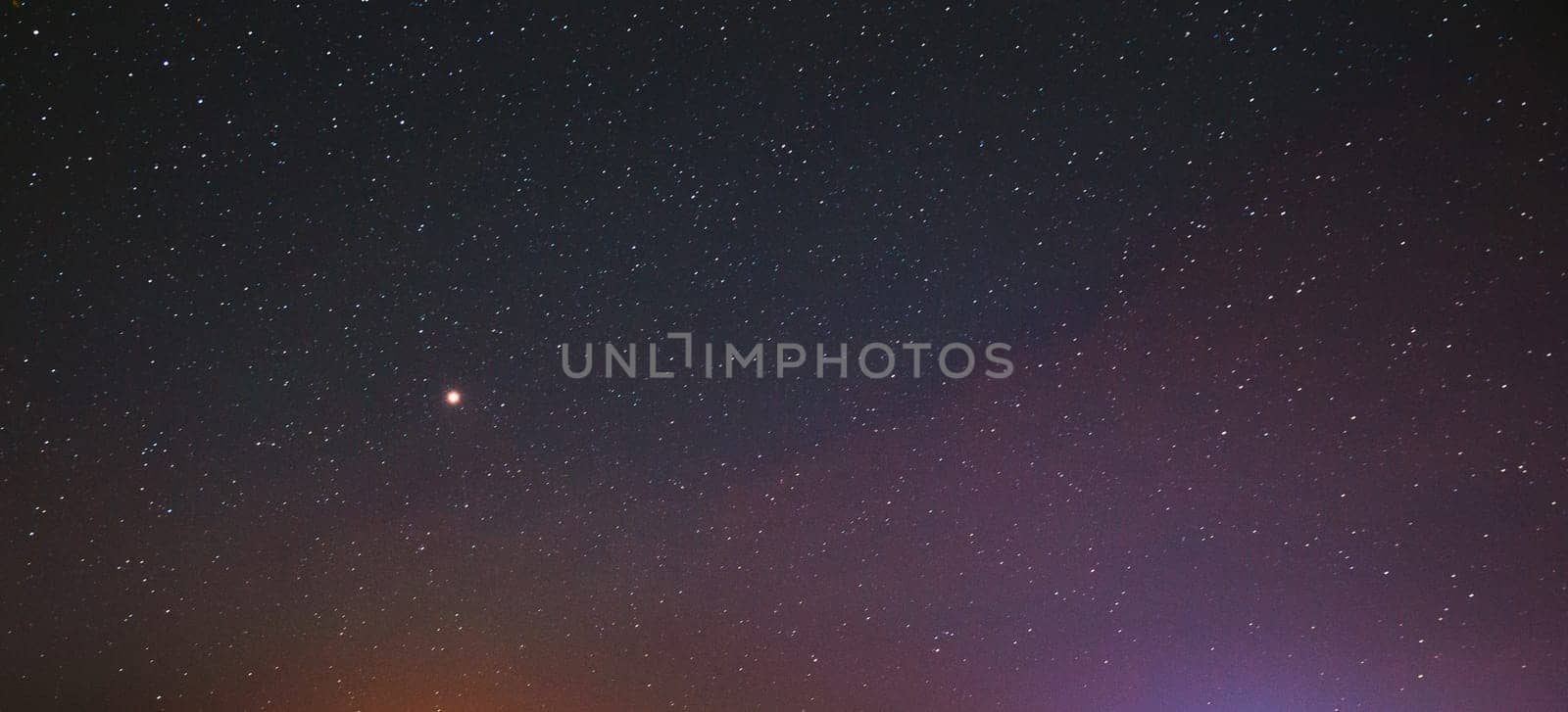 Night Starry Sky With Glowing Stars. Bright Glow Of Planet Venus In Sky Among Stars. Sky In Lights Of Sunset Dawn.