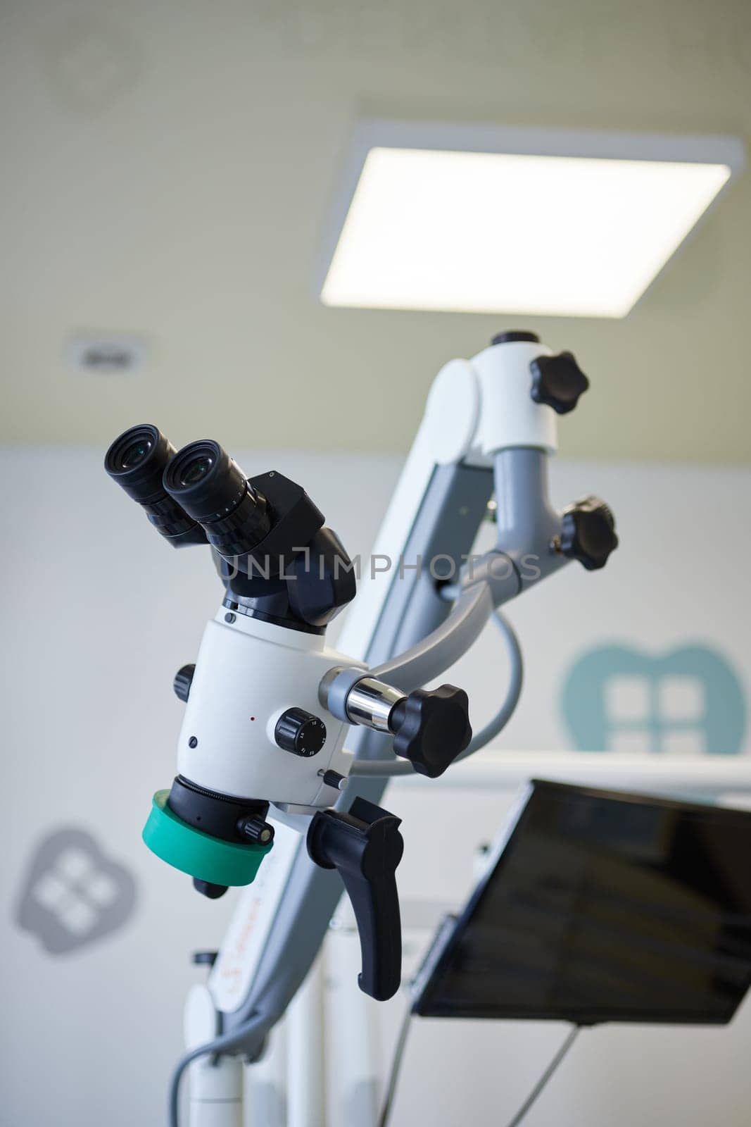 Medical equipment for dentistry. Modern microscope for operations in dental surgery room in stomatology clinic. Close up of professional dental endodontic binocular microscope.