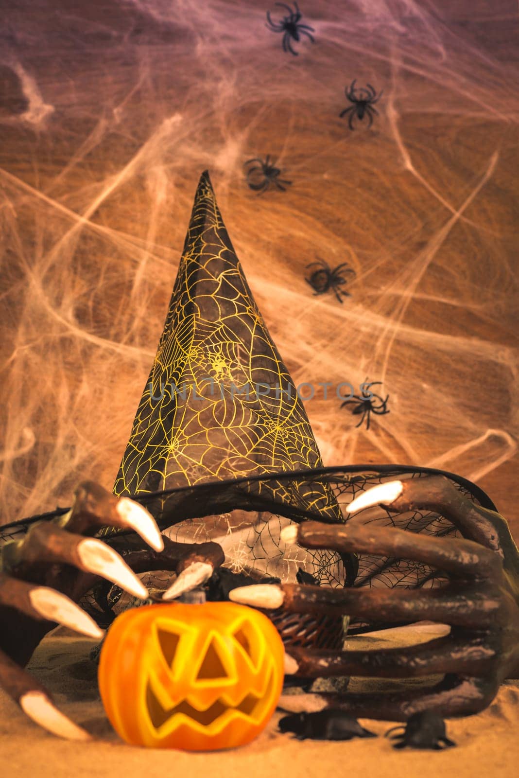 Halloween concept with witch hands, cobweb, spiders, rats and Jack o lantern ornament