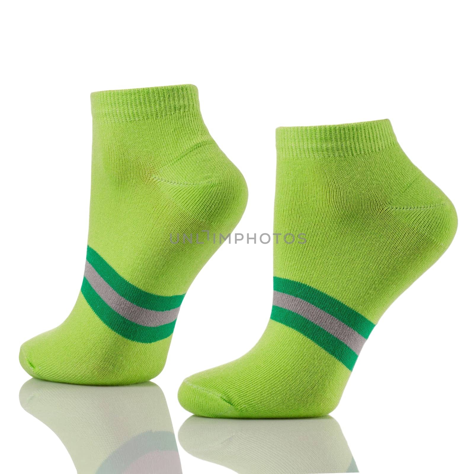 Close up of pair of sports cotton socks on invisible legs isolated on white background. Set of short green socks for advertising, logo or branding layout.