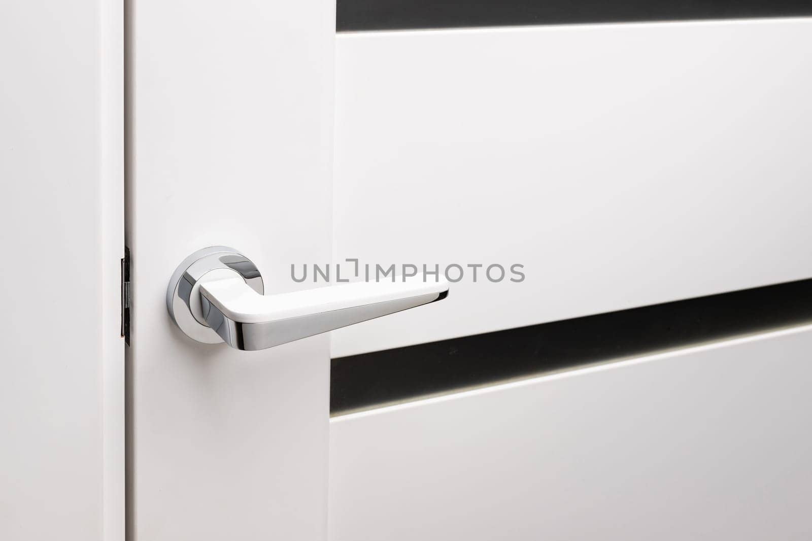 Door handles elements close up. Door handle on white closed doors in modern loft style in interior. Concept of accessories for interior design home interior of apartment or office.