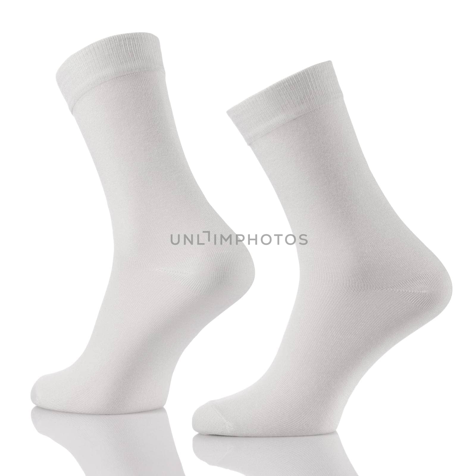 Close up of white cotton long sock on invisible foots isolated on white background. Layout for advertising, branding, design or template.