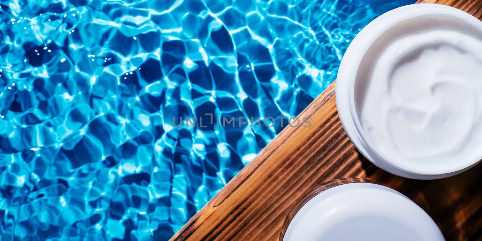 White plastic open jar of facial and body cream gel collagen for anti aging sculpting wrinkles. Water rippled. Professional spa relaxation moisturizer, healthy skin care. Flat lay, banner, copy space.