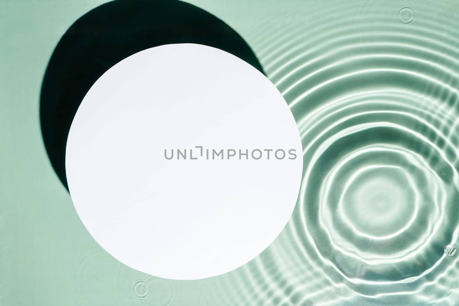 White circle copy space in transparent fresh green blue water drop splashing gel surface with flecks, waves, shade. Health care relaxation. Vacation coast sea natural concept. Flat lay. Place for text