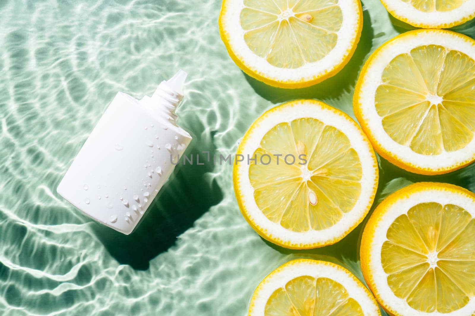 White beauty product sunscreen cream vial tube bottle in transparent fresh exhilarant wave water with flecks, lemon citrus slices. Body skin care protection in summer beach travel concept. Flat lay.