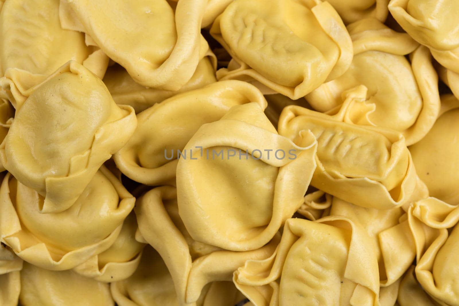 tasted italian food. Quantity of ravioli pasta as a background. Top view style
