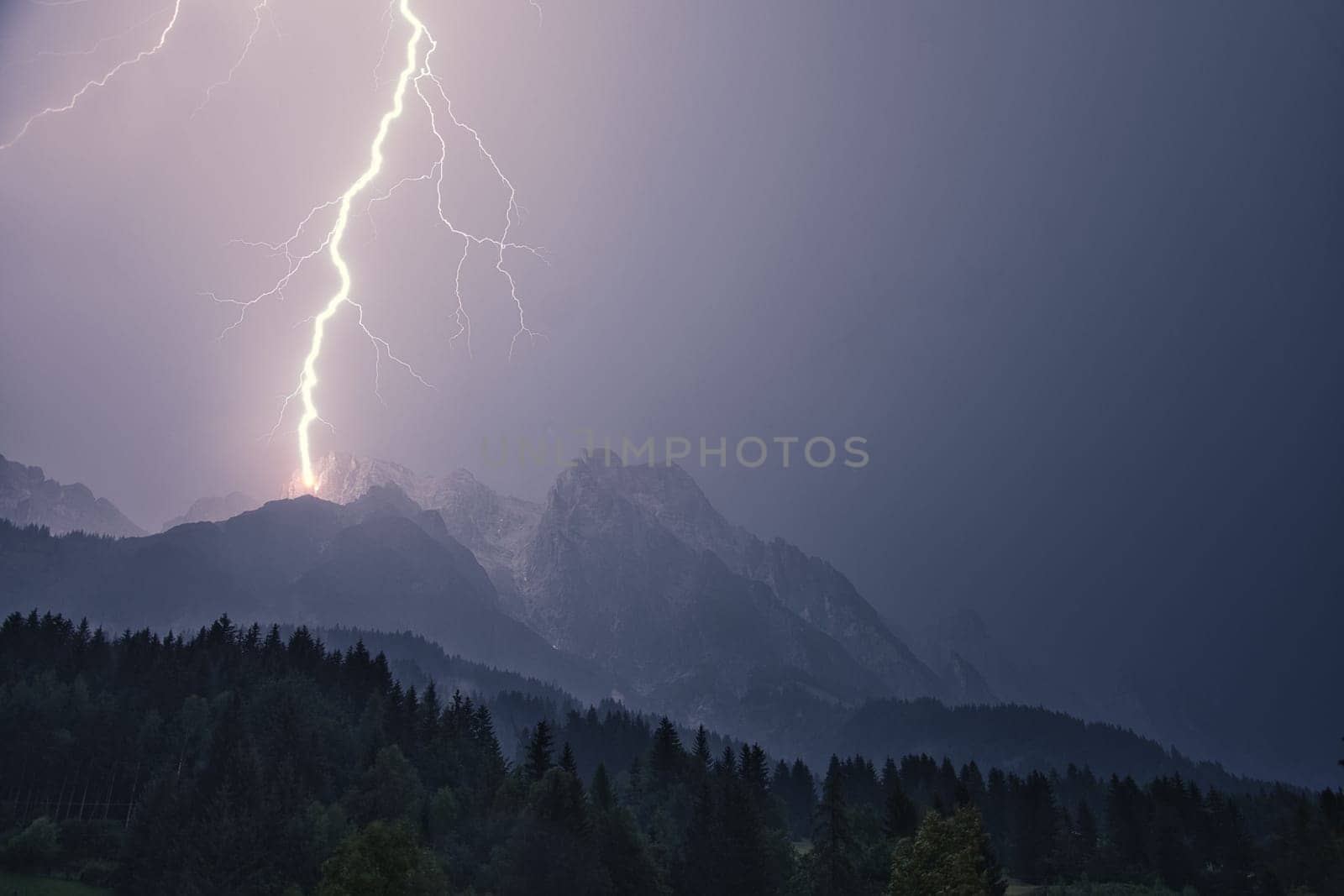 Dramatic lightning strike during a thunderstorm in the Steinberg in Leogang, Salzburg, Austria