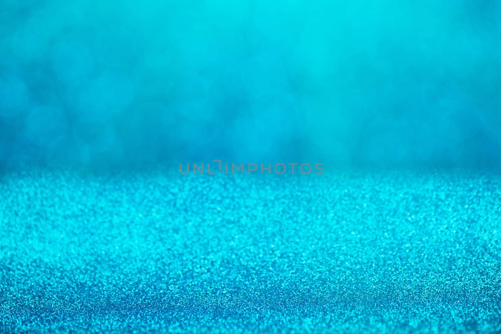 Blue bokeh background for christmas, defocused round lights and sunbeams, flare overlay