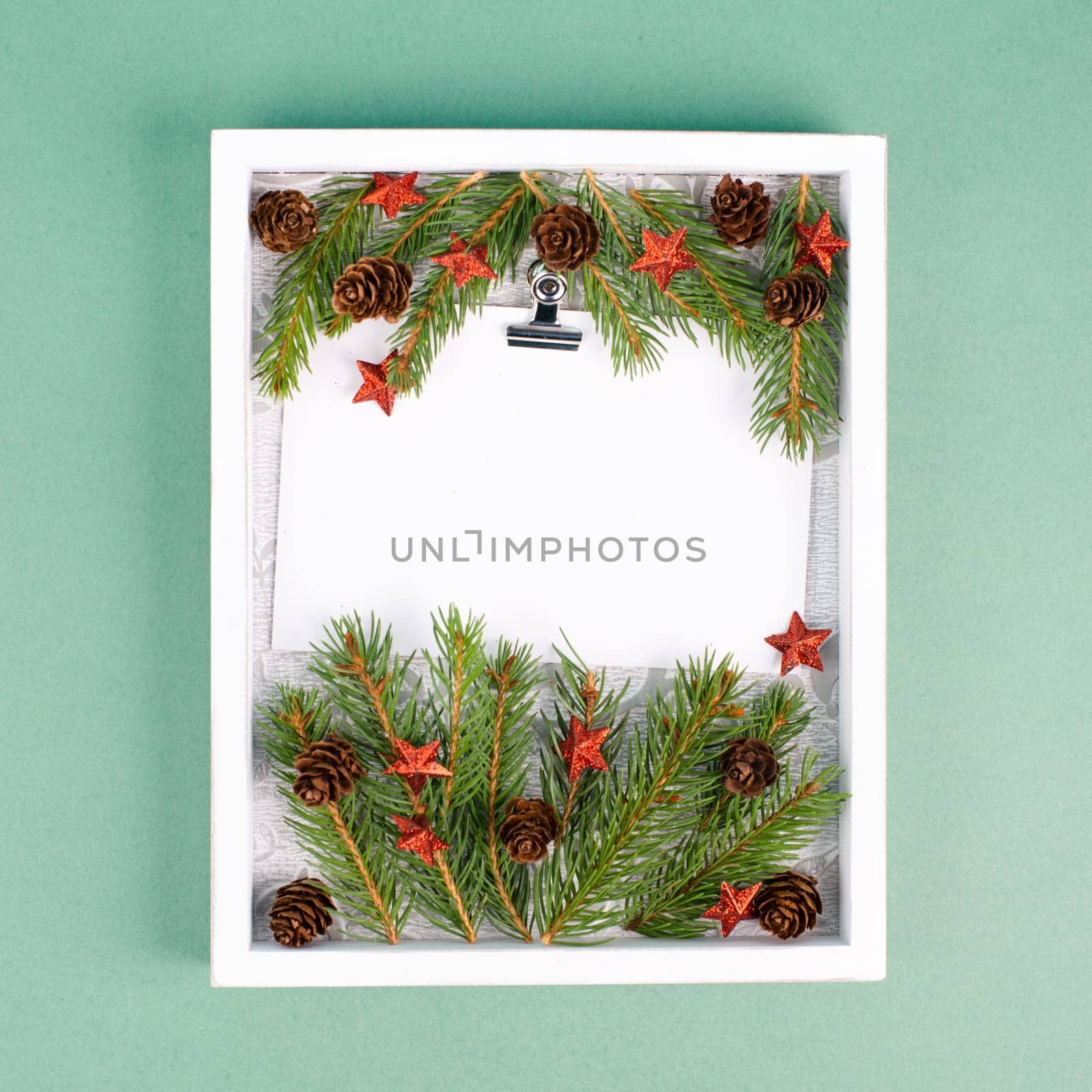 Christmas holiday background, frame with fir branches, stars, candy cane and pine cones, winter season greeting card
