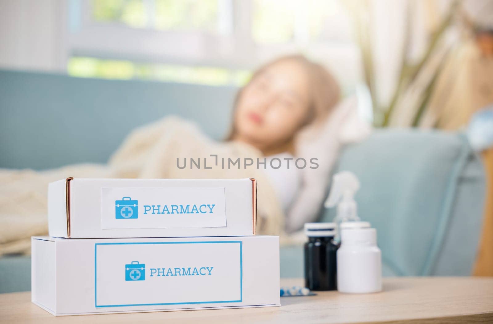 Asian young woman tired sick she sleep and resting on sofa after take medicines pills in living room at home, beautiful female use pharmacy first aid kit box delivery service from hospital, healthcare