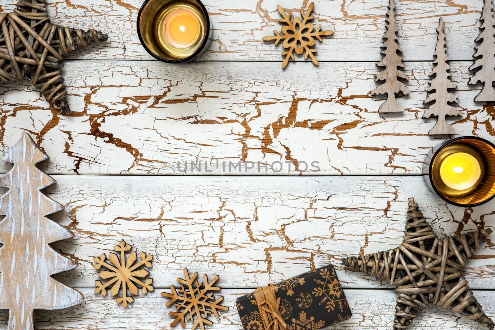 White Vintage Wooden Christmas Background With Christmas Decoration Like Candle, Tree, Snowflake, Stars and Gift. Rustic Card With Copy Space.