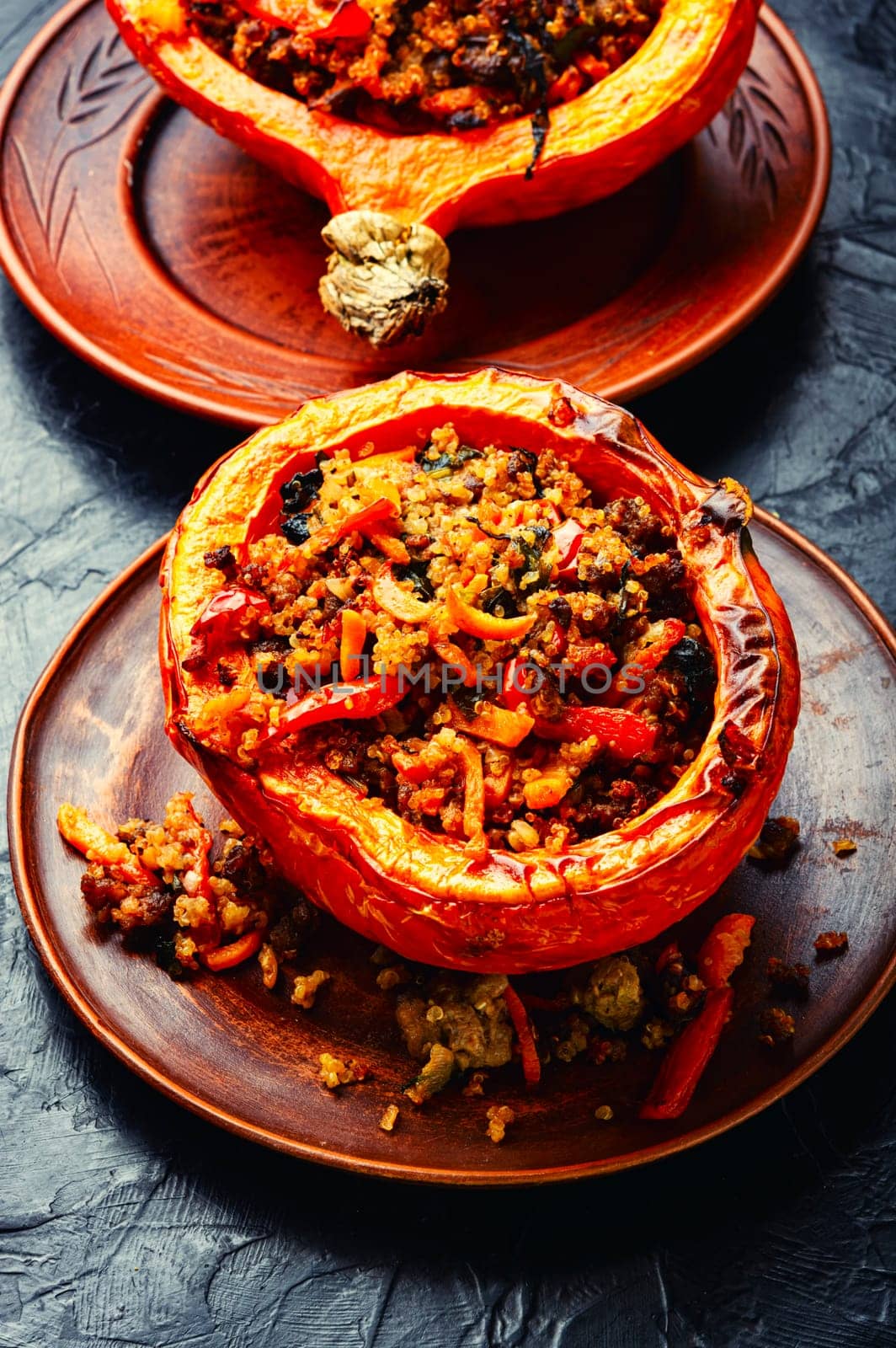 Baked pumpkin stuffed with vegetables, a popular autumn food.Roasted squash, wooden table
