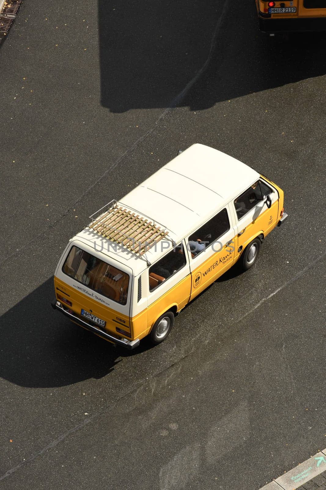 Closeup shot of a white and yellow bus on a road