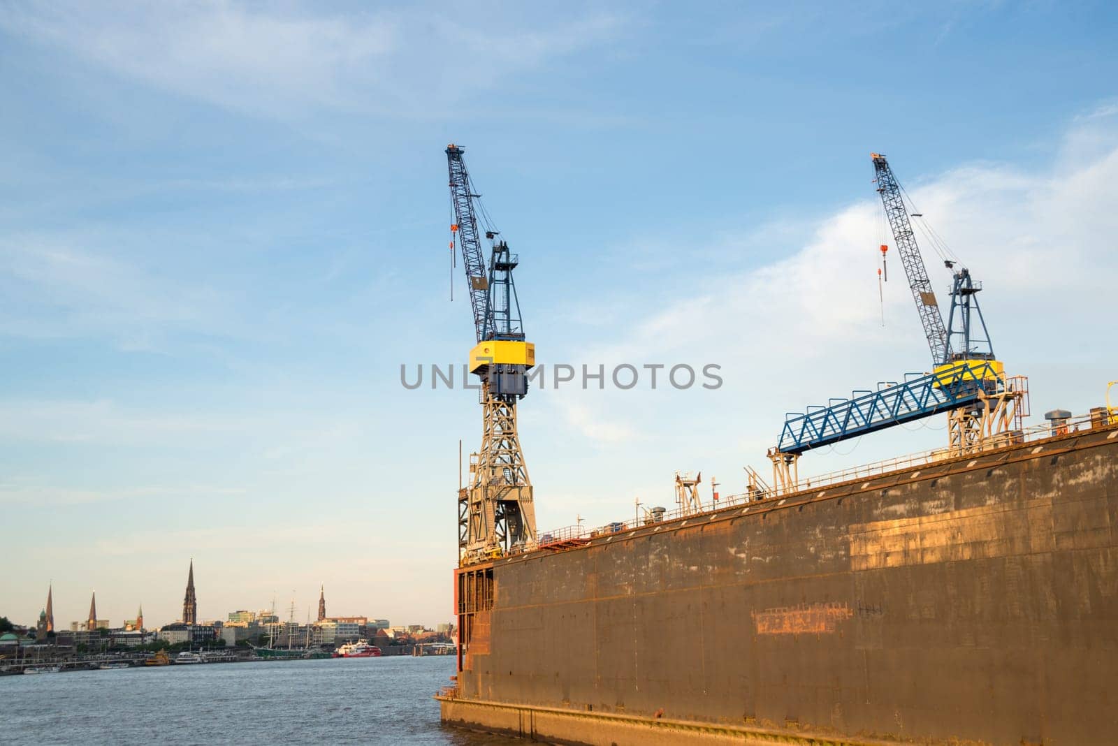 Hamburg view with dock and crane in front on the elbe