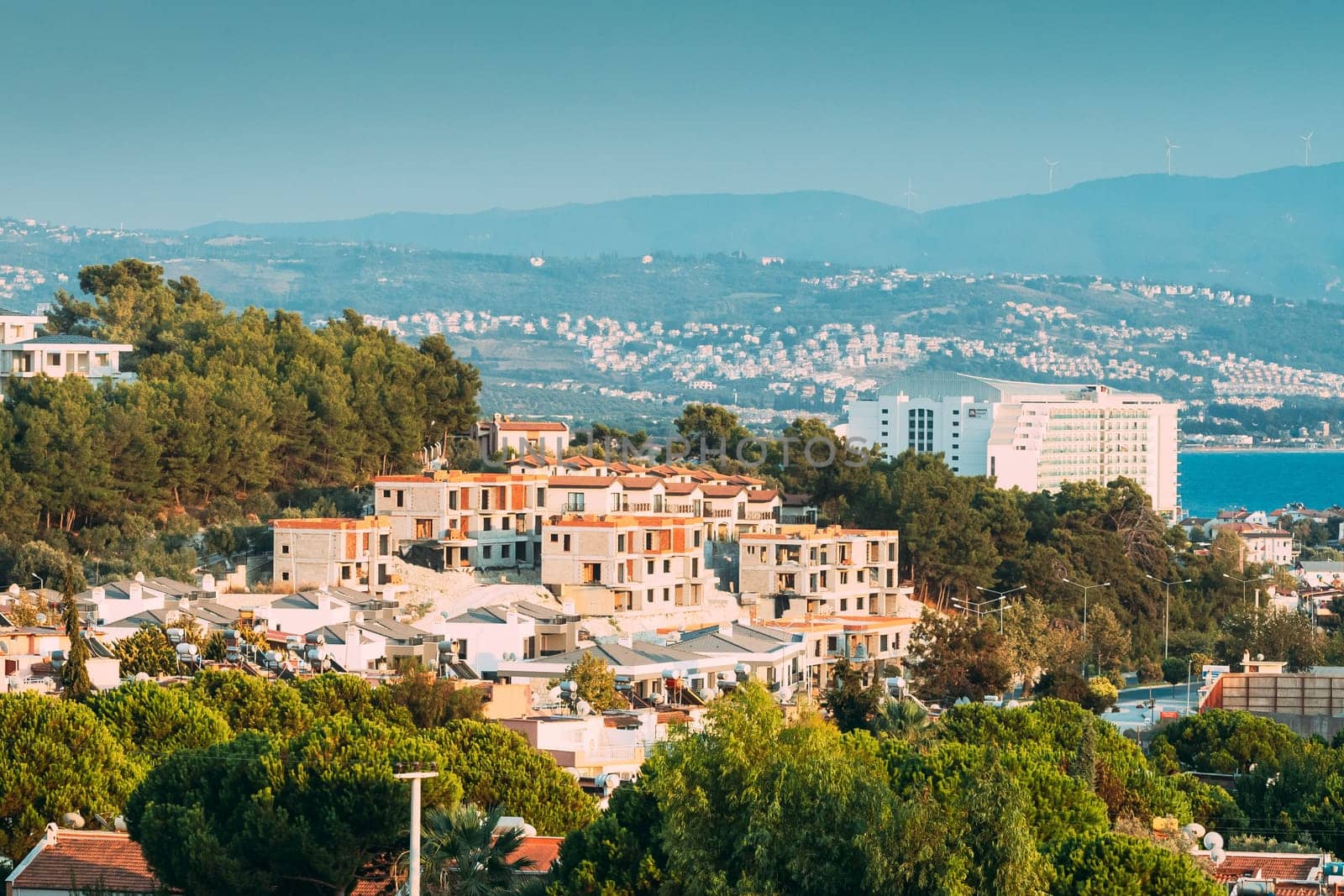 Kusadasi, Turkey. Beautiful Cityscape Of Turkish Town. White Residential Houses On Hillside. Real Estate Suburb In Summer Evening.