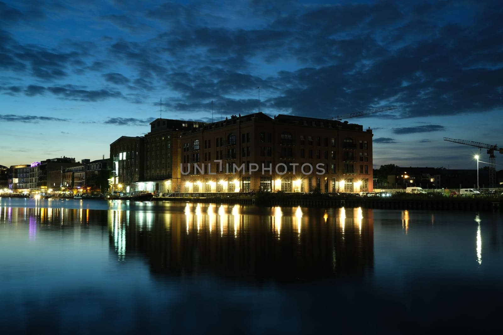 Old brick building illuminated at sunset in the harbor of Munster, Germany