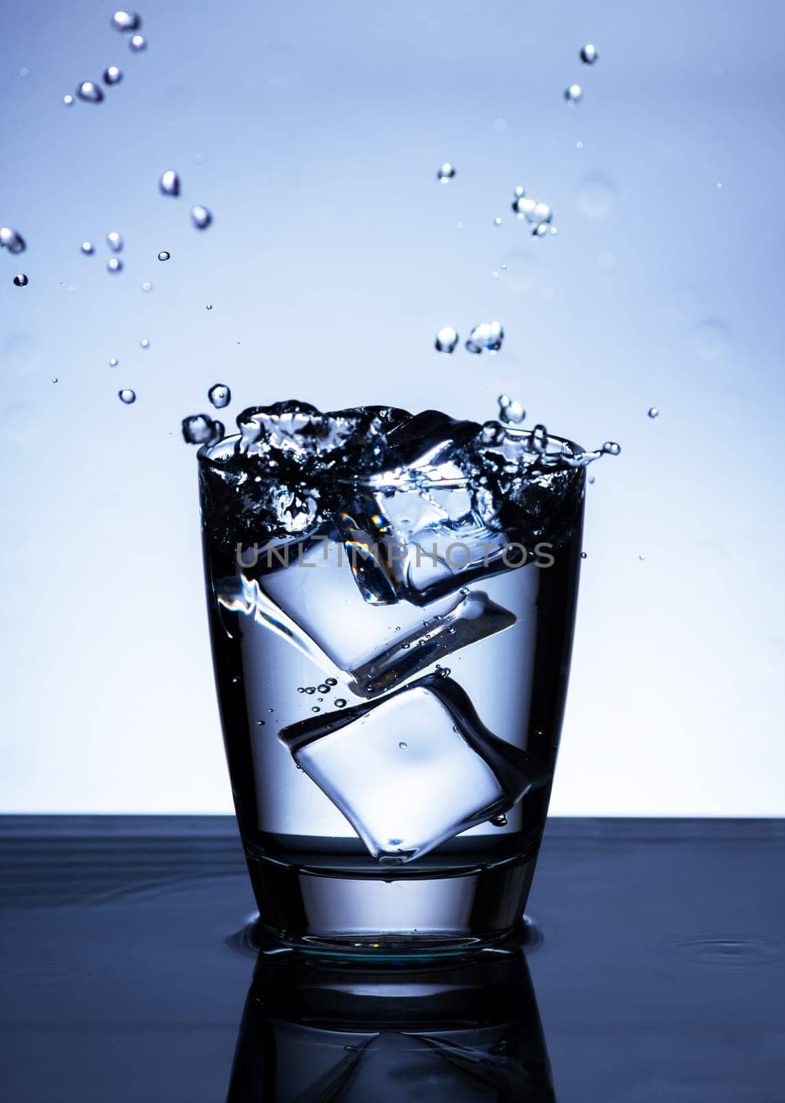 The image of pouring drinking water, into a glass, that makes one feel refreshed on blurred white background, Splashing water, Sparkling water