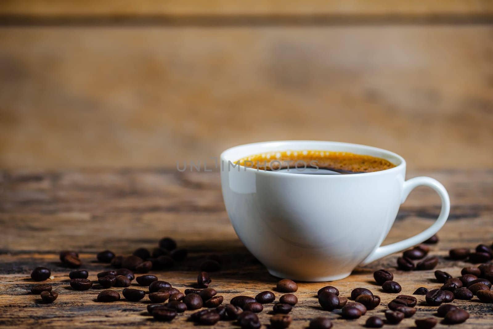 A cup of coffee with coffee bean on wooden background dark tone dtyle
