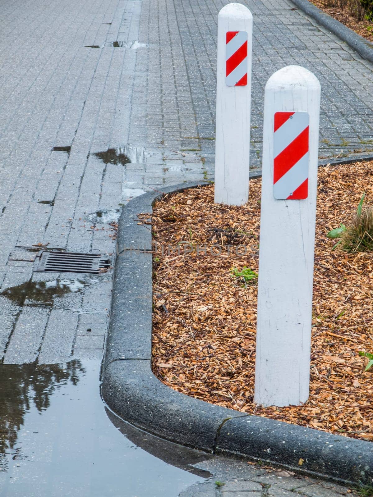 View of a bottleneck with two street bollards on a side street at the port of Harlesiel.