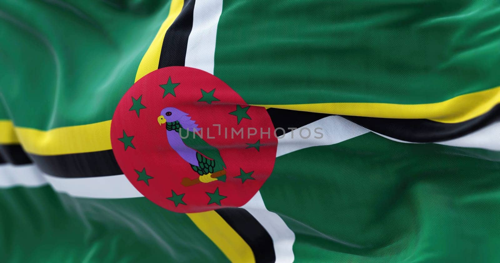 Close-up view of the Dominica national flag waving in the wind. The Commonwealth of Dominica, is an island country in the Caribbean Fabric textured background. Selective focus