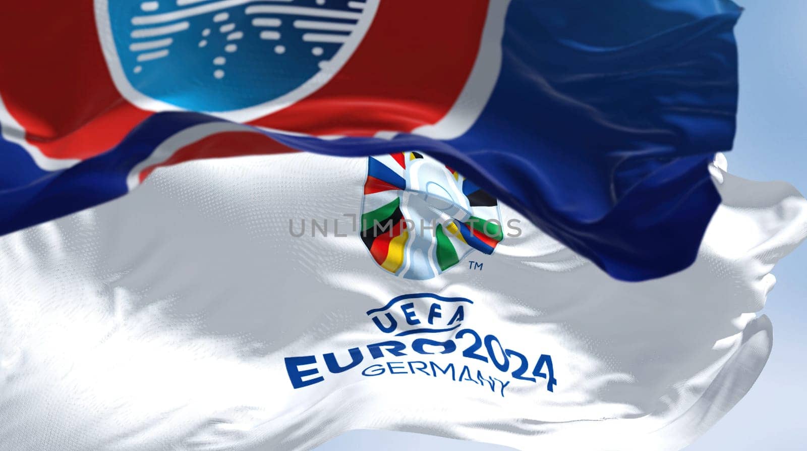 Berlin, Ger, October 2022: UEFA and UEFA Euro 2024 flags flying in the wind. The 17th edition will take place from 14 June to 14 July 2024 in Germany. Selective focus. International sport event