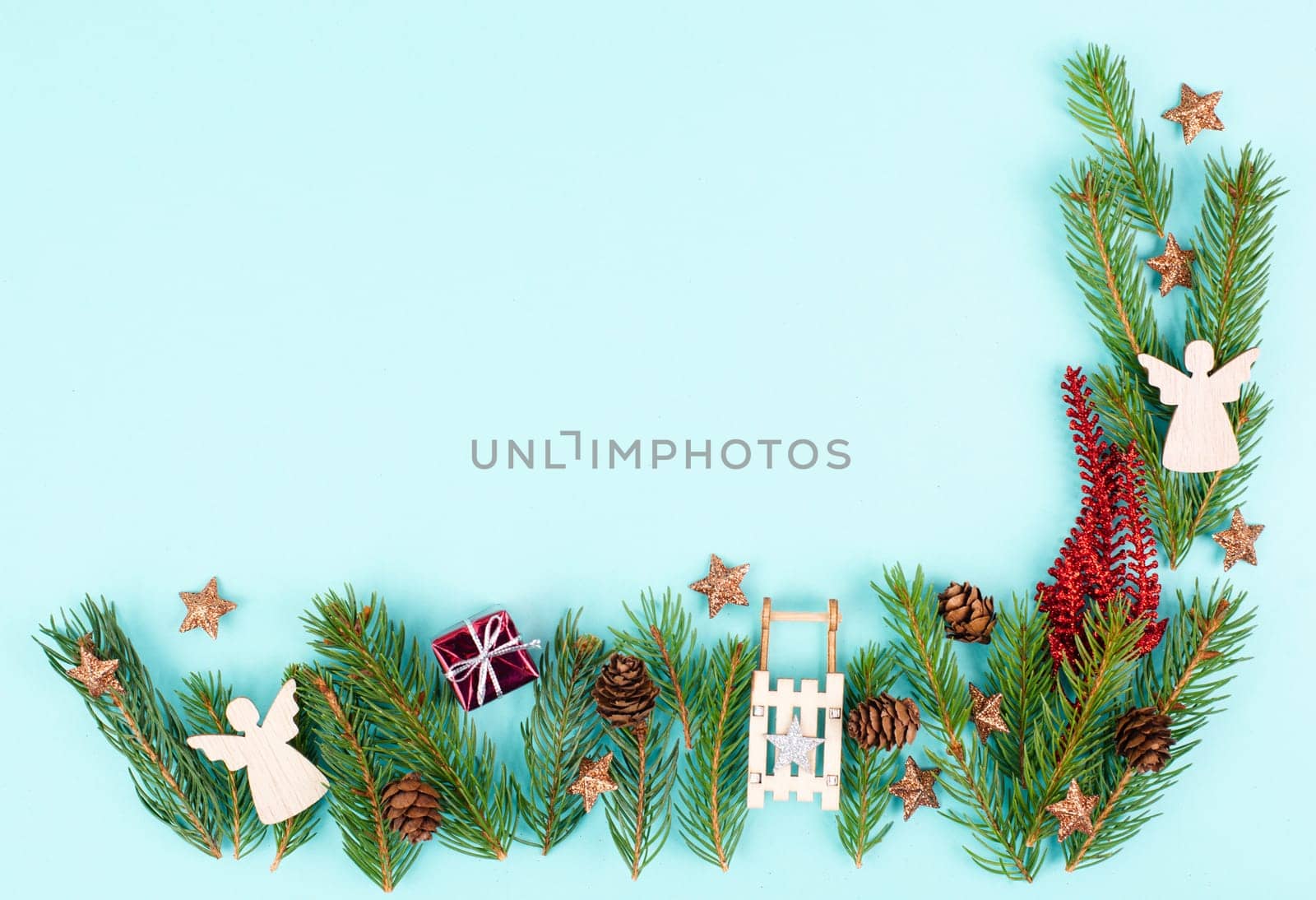 Christmas holiday background with fir branches, pine cones, angels and a sledge, winter season greeting card