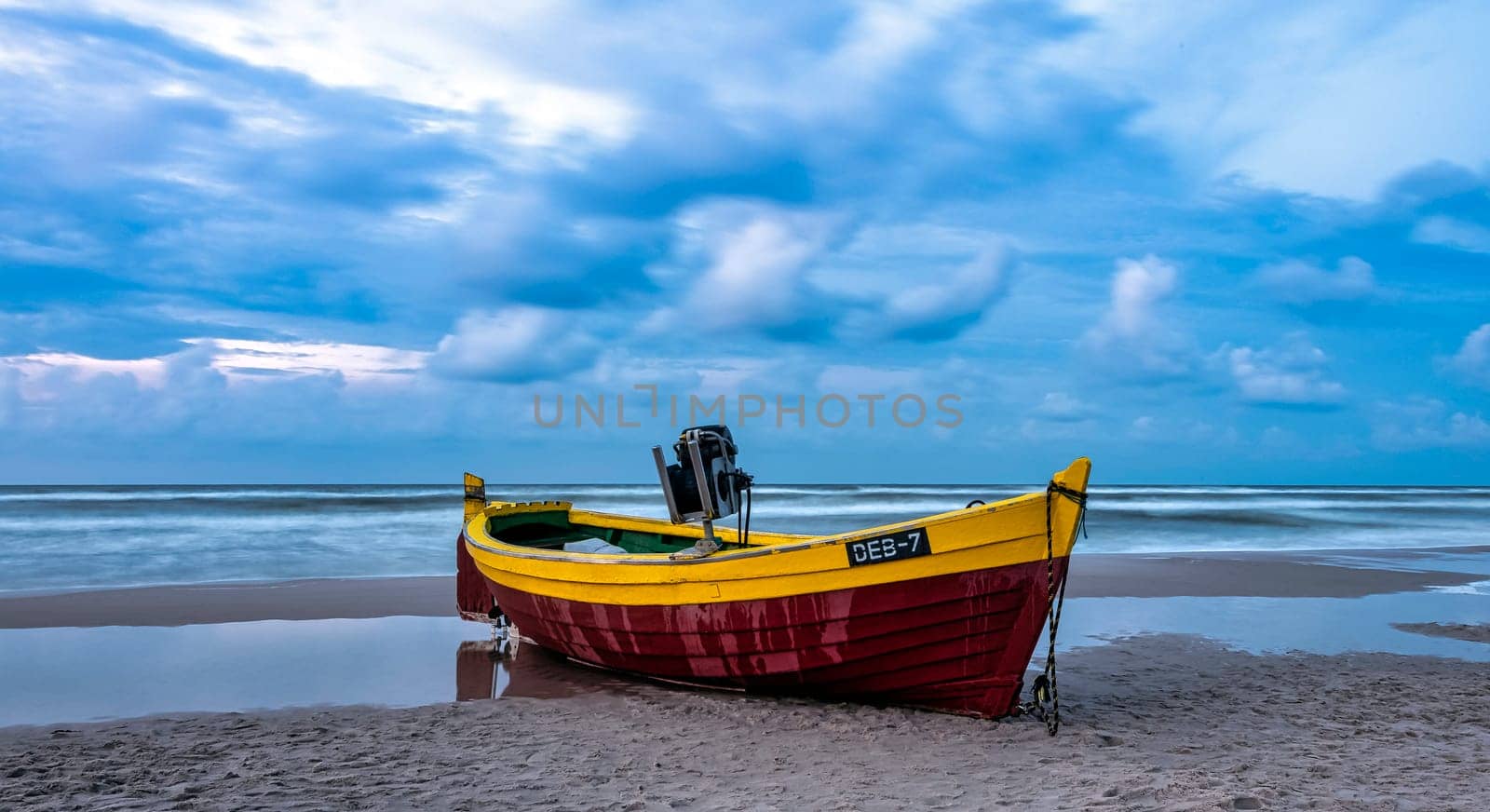 Sunset over Baltic Sea with fishing boat on the beach - Debki, Pomerania, Poland