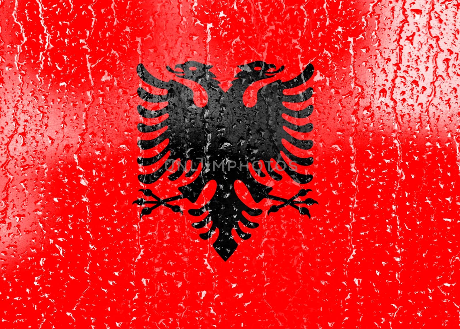 3D Flag of Albania on a glass with water drop background.