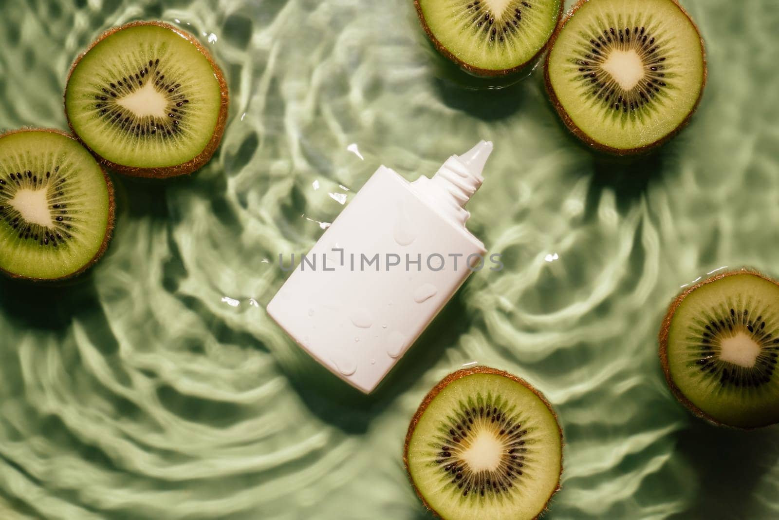 White beauty product sunscreen cream vial tube bottle in transparent fresh exhilarant wave water with flecks, lemon citrus slices. Body skin care protection in summer beach travel concept. Flat lay.